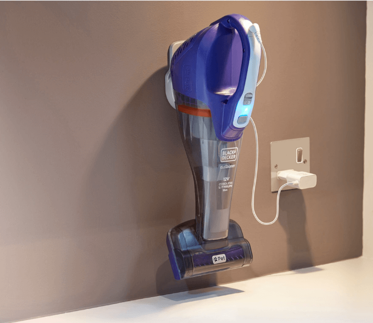 Close-up of the Black+Decker Pet Dustbuster motorized head with rubber tines, designed to remove embedded dog and cat hair from fabric.