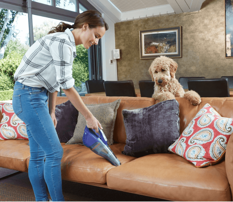 Cordless Black+Decker DVB315JP-GB 12V Dustbuster cleaning car interior and upholstery, showcasing lightweight and portable design.